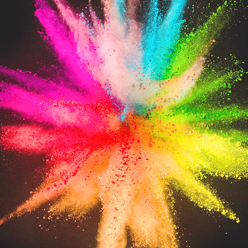 Colored powder explosion on black background